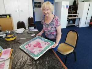 An older woman doing crafts